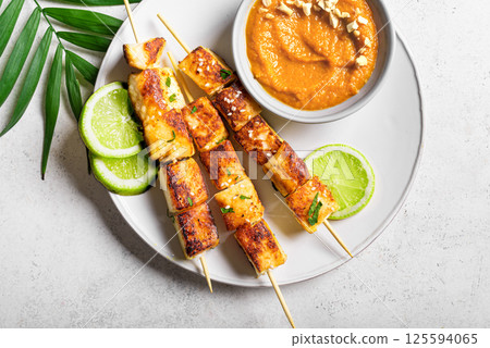 Grilled tofu satay skewers and peanut spicy sauce 125594065