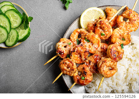 Grilled shimp prawn satay skewers with steamed rice 125594126