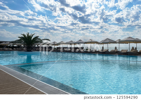 Outdoor swimming pool on Mandarin Adler beach. Russia, Sochi, 10.10.2024 Outdoor swimming pool on Mandarin Adler beach. Russia, Sochi, 10.10.2024 125594290