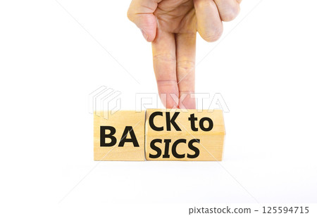Back to basics symbol. Concept words Back to basics on wooden block. Beautiful white table white background. Businessman hand. Business back to basics concept. Copy space. Back to basics symbol. Concept words Back to basics on wooden block. Beautiful white table white background. Businessman hand. Business back to basics concept. Copy space. 125594715