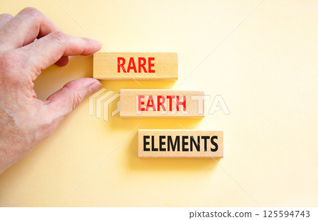 Rare earth elements symbol. Concept words Rare earth elements on beautiful wooden block. Businessman's hand. Beautiful white background. Business and rare earth elements concept. Copy space. 125594743