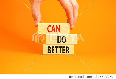 Can do better symbol. Concept words Can do better on beautiful wooden block. Businessman's hand. Beautiful orange background. Business and can do better concept. Copy space. 125594760