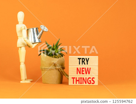 Try new things symbol. Concept words Try new things on beautiful wooden block. Businessman model. Beautiful orange background. Business motivational lifestyle try new things concept. Copy space. Try new things symbol. Concept words Try new things on beautiful wooden block. Businessman model. Beautiful orange background. Business motivational lifestyle try new things concept. Copy space. 125594762