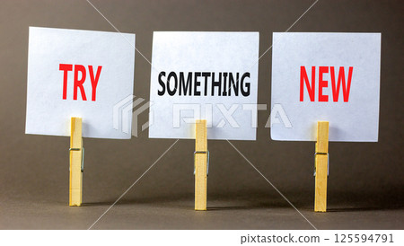 Try something new symbol. Concept words Try something new on beautiful white paper on wooden clothespin. Beautiful grey background. Business motivational lifestyle try something new concept Copy space 125594791