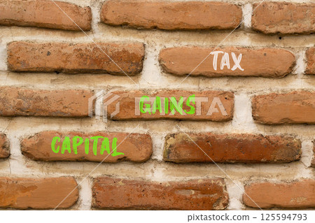 Capital gains tax symbol. Concept words Capital gains tax on beautiful brown brick wall. Beautiful brown brick wall background. Business and capital gains tax concept. Copy space. 125594793