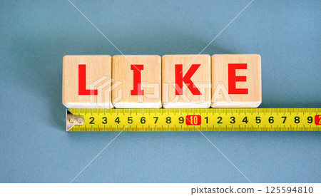 Like symbol. Concept word Like on beautiful wooden blocks. Beautiful yellow ruler. Beautiful blue table blue background. Business, lifestyle, support and like concept. Copy space. Like symbol. Concept word Like on beautiful wooden blocks. Beautiful yellow ruler. Beautiful blue table blue background. Business, lifestyle, support and like concept. Copy space. 125594810