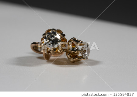Diamond Earrings Isolated on White Background. Yellow Gold Diamond Earring Pair with 750 Stamp Denoting 18-Carat Yellow Gold. 125594837