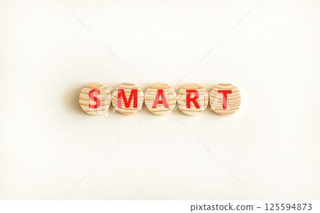 Smart symbol. Concept word Smart on beautiful wooden circles. Beautiful white table white background. Business lifestyle smart concept. Copy space. Smart symbol. Concept word Smart on beautiful wooden circles. Beautiful white table white background. Business lifestyle smart concept. Copy space. 125594873