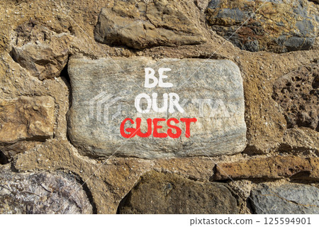 Be our guest symbol. Concept words Be our guest on beautiful grey stone wall. Beautiful stone wall background. Business and be our guest concept. Copy space. 125594901