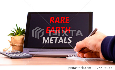 Rare earth metals symbol. Concept words Rare earth metals on beautiful black tablet. Businessman hand. Beautiful white background. Business and rare earth metals concept. Copy space. Rare earth metals symbol. Concept words Rare earth metals on beautiful black tablet. Businessman hand. Beautiful white background. Business and rare earth metals concept. Copy space. 125594957