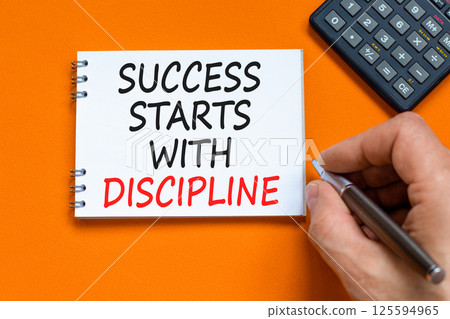 Success starts with discipline symbol. Concept words Success starts with discipline on beautiful white note. Beautiful orange background. Business success starts with discipline concept. Copy space Success starts with discipline symbol. Concept words Success starts with discipline on beautiful white note. Beautiful orange background. Business success starts with discipline concept. Copy space 125594965