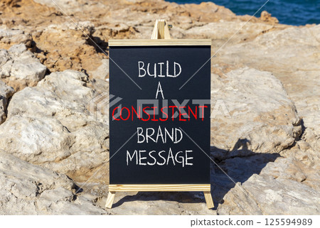 Consistent brand message symbol. Concept words build a consistent brand message on beautiful black chalkboard. Beautiful stone sea background. Business consistent brand message concept. Copy space. 125594989