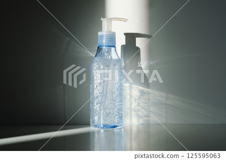 Tube of micellar gel in a ray of sunlight on a shadow background. 125595063