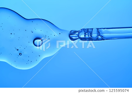 The texture of the moisturizing antiage serum on a blue background. The texture of the moisturizing antiage serum on a blue background. 125595074