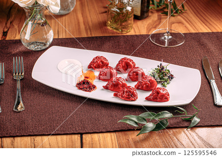 Gourmet red colored dumplings with sauce Gourmet red colored dumplings with sauce 125595546