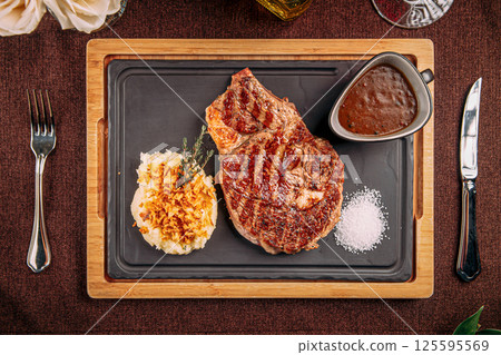 Grilled steak with mashed potato and fried onion 125595569