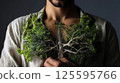Person with a tree growing from their chest, branches reaching outward 125595766