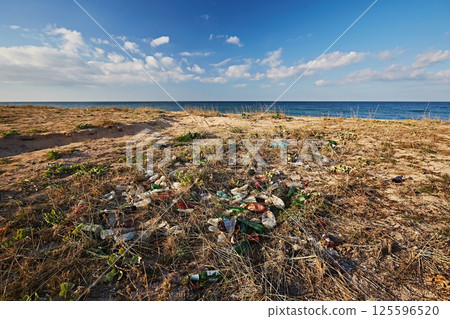 Trash from tourists on the beach by the sea Trash from tourists on the beach by the sea 125596520