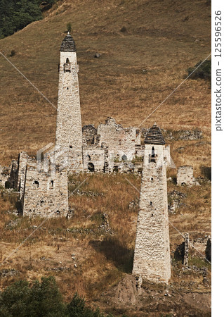 High stone towers in the Caucasus, medieval castle and town in the mountains, close-up 125596526
