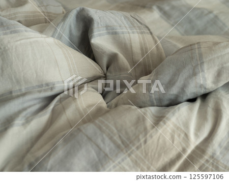 A detailed closeup view of a wonderfully soft, textured blanket, emphasizing its inviting and cozy design 125597106