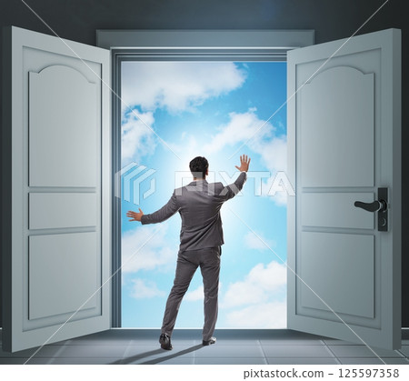 Businessman entering big large door Businessman entering big large door 125597358
