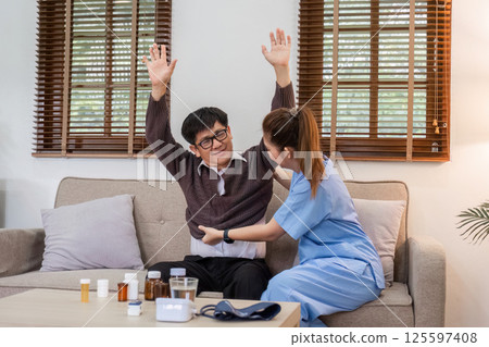 Elderly Caregiver Assisting Retired Man in Comfortable Home Setting for Health and Well-being Elderly Caregiver Assisting Retired Man in Comfortable Home Setting for Health and Well-being 125597408