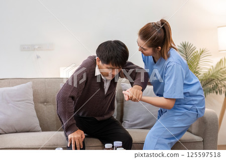 Elderly Caregiver Assisting Retired Man at Home for Improved Comfort and Well-being in a Supportive Environment Elderly Caregiver Assisting Retired Man at Home for Improved Comfort and Well-being in a Supportive Environment 125597518