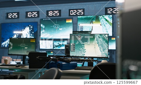 Secure room in army governmental facility operating as military command post and surveillance monitoring center, filled with digital equipment. Empty military base of operations with radar systems 125599667