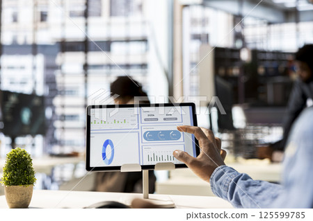 Male entrepreneur conducting financial planning and goal setting, demonstrating expertise in budget management. CEO analyzing online reports and forecasts to drive company growth plans. Close up. 125599785