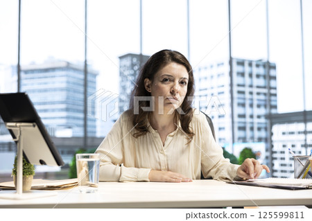 Female CEO strategically planning activity for business growth and global development, demonstrating her leadership qualities and goal orientation. Dedication to corporate success. Female CEO strategically planning activity for business growth and global development, demonstrating her leadership qualities and goal orientation. Dedication to corporate success. 125599811