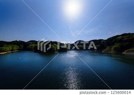 Fresh greenery at Nara Nunome Dam. Beautiful reflection of the cloudy sky and lake surface as the sun sets. Still image 4 125600014