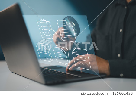 Symbolizes a digital audit process involving thorough inspection of electronic documents and records. 125601456