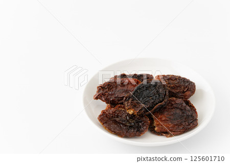Sun-dried tomatoes on a plate 125601710