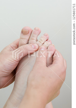 Close up of a woman's foot being massaged.  125601711