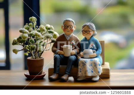 Elderly couple enjoying tea together in cozy indoor setting during daytime 125601888