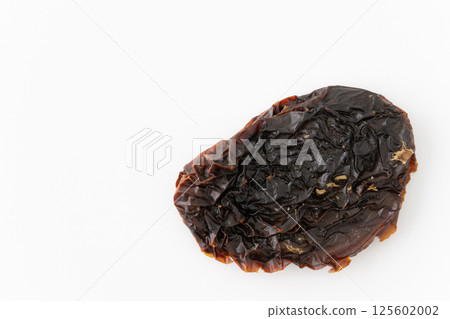 Sun-dried tomatoes on a white background Sun-dried tomatoes on a white background 125602002