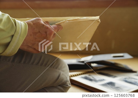 一位老人在整理行李時回憶往事 一位老人在整理行李時回憶往事 125603768