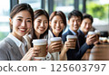 Happy diverse business team enjoys coffee break together in office. 125603797