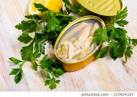 Canned natural mollusks Solen with parsley and lemon Canned natural mollusks Solen with parsley and lemon 125604187