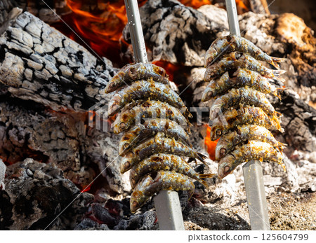 Sardines on skewers are cooked on fire. Andalusia 125604799