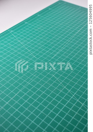 green cutting mat board on white background with line and scale measure guide pattern for art design green cutting mat board on white background with line and scale measure guide pattern for art design 125604995