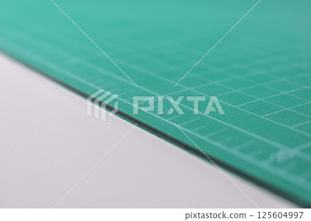 green cutting mat board on white background with line and scale measure guide pattern for art design green cutting mat board on white background with line and scale measure guide pattern for art design 125604997