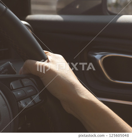 female driver hand hold steering wheel drive vehicle car rode trip travel 125605048