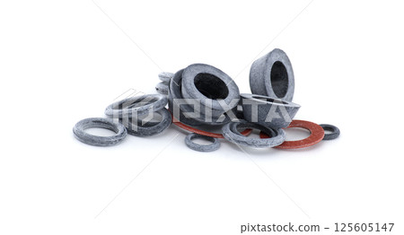 Various rubber gaskets and seals are stacked on a white background, perfect for industrial use. Various rubber gaskets and seals are stacked on a white background, perfect for industrial use. 125605147