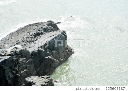 some weathered eroded cracked rocks on the coastline some weathered eroded cracked rocks on the coastline 125605187