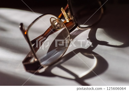 Eyeglasses on a white background with shadows. Selective focus. 125606064