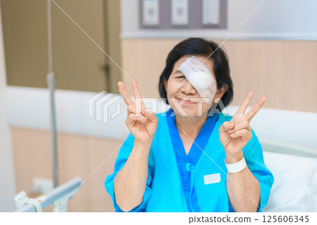 Elderly Woman with eye protective shield after eye surgery. Eye disease, Cataract, Glaucoma, Age Related Macular Degeneration, Diabetic Retinopathy, Vitreous, Lasik, World Glaucoma day and health Elderly Woman with eye protective shield after eye surgery. Eye disease, Cataract, Glaucoma, Age Related Macular Degeneration, Diabetic Retinopathy, Vitreous, Lasik, World Glaucoma day and health 125606345