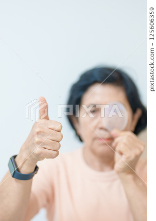Elderly Woman with eye protective shield after eye surgery. Eye disease, Cataract,  Glaucoma, Age Related Macular Degeneration, Diabetic Retinopathy, Vitreous, Lasik, World Glaucoma day and health 125606359