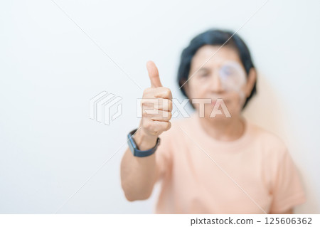 Elderly Woman with eye protective shield after eye surgery. Eye disease, Cataract,  Glaucoma, Age Related Macular Degeneration, Diabetic Retinopathy, Vitreous, Lasik, World Glaucoma day and health 125606362