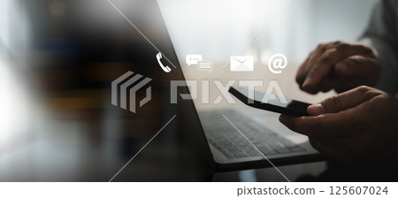 contact us Close up Man using smart phone chatting  contact us his office desk using a laptop computer global internet networking, social media 125607024